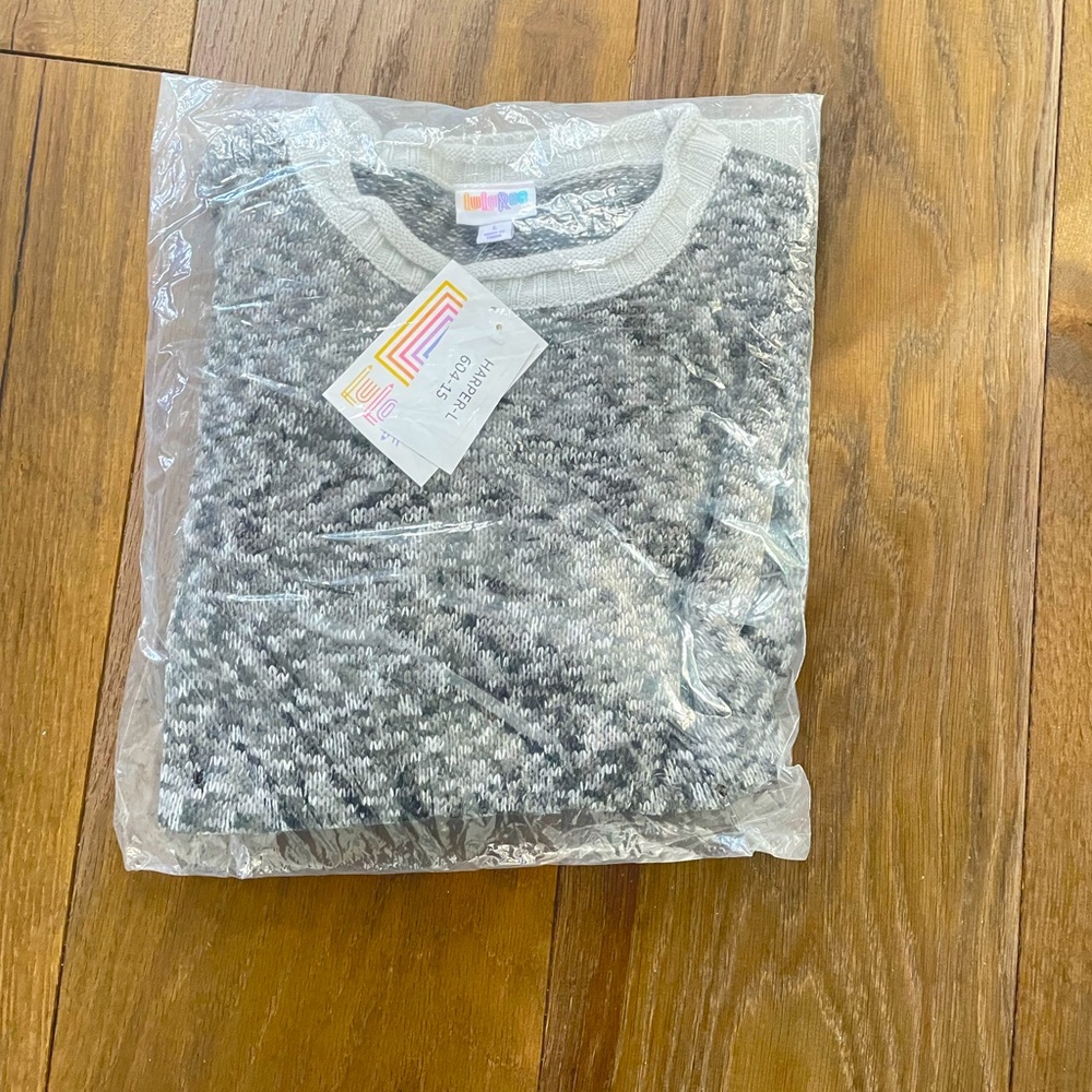 Package never opened. Black, grey and white hues.
